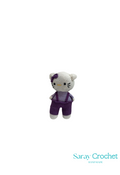 A crocheted representation of Hello Kitty in purple and gray colors, with a logo watermarked below.