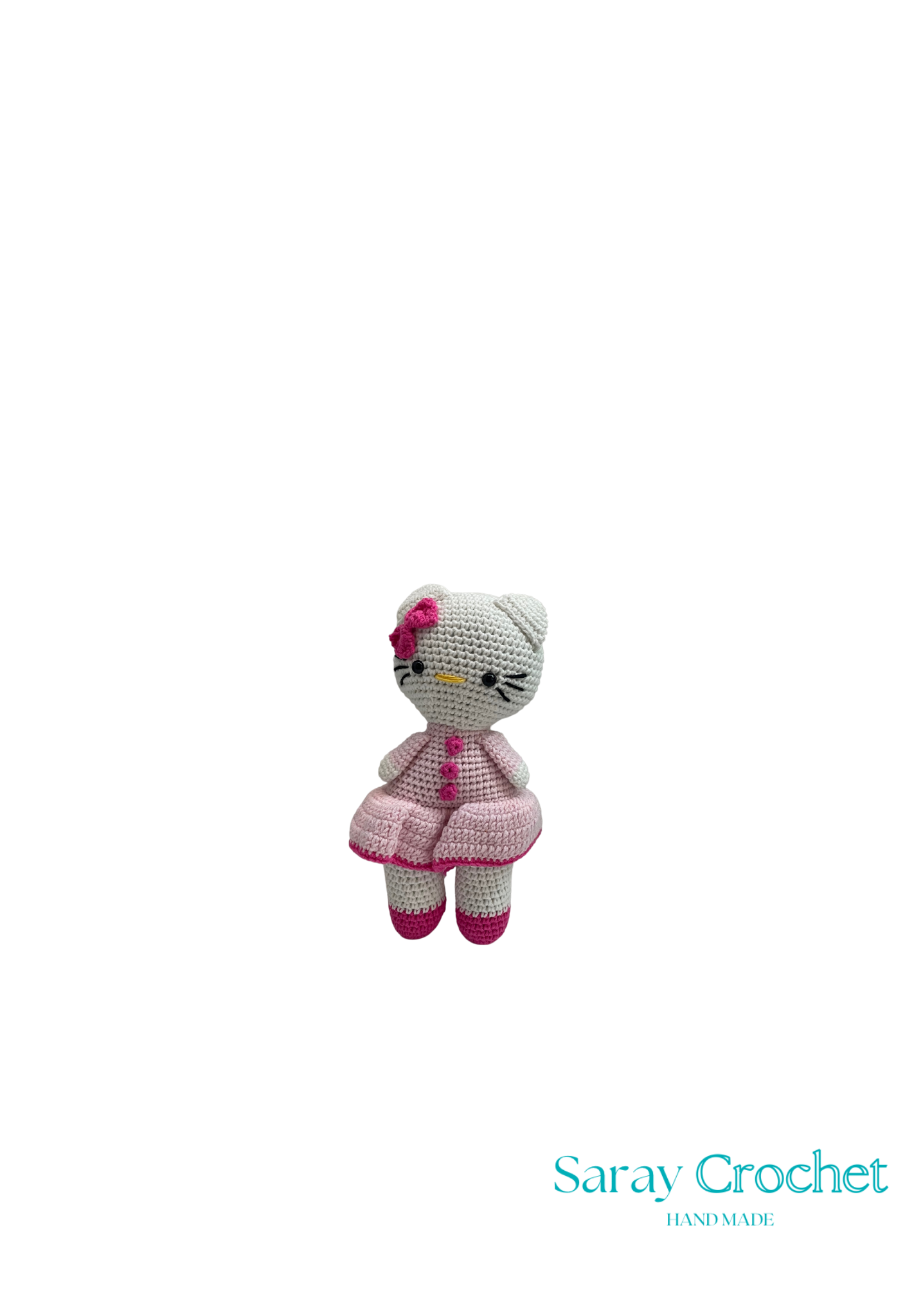 A crochet doll resembling Hello Kitty, wearing a pink dress and bow, with a white base color, against a white background with the text 'Saray Crochet'.