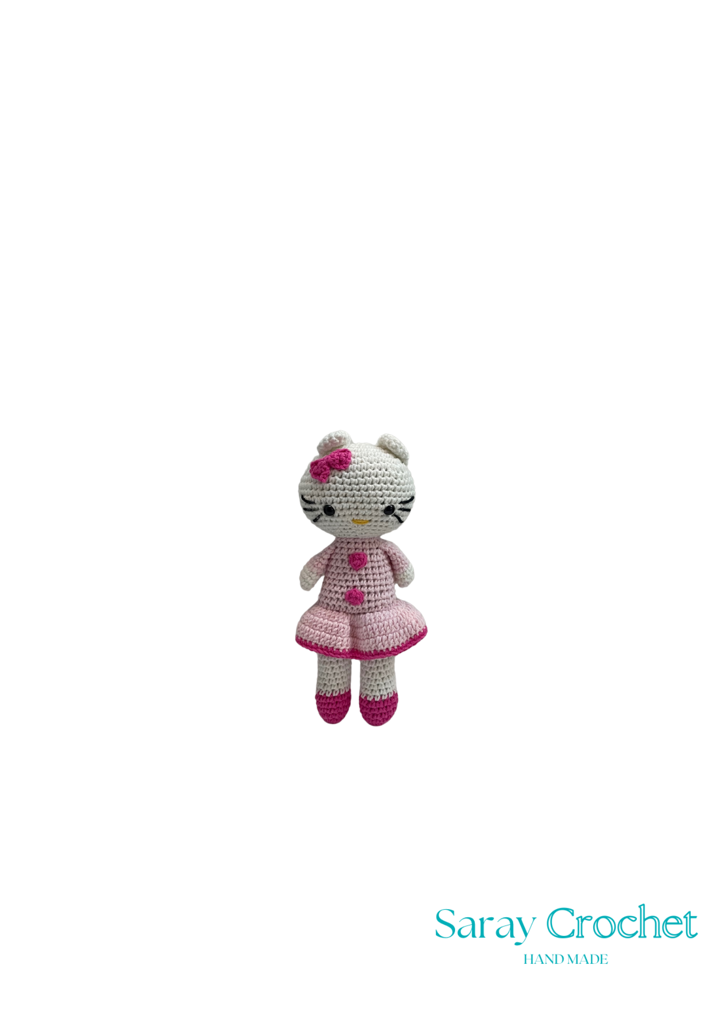 A crochet doll resembling Hello Kitty, wearing a pink dress and bow, with a white base and facial features.