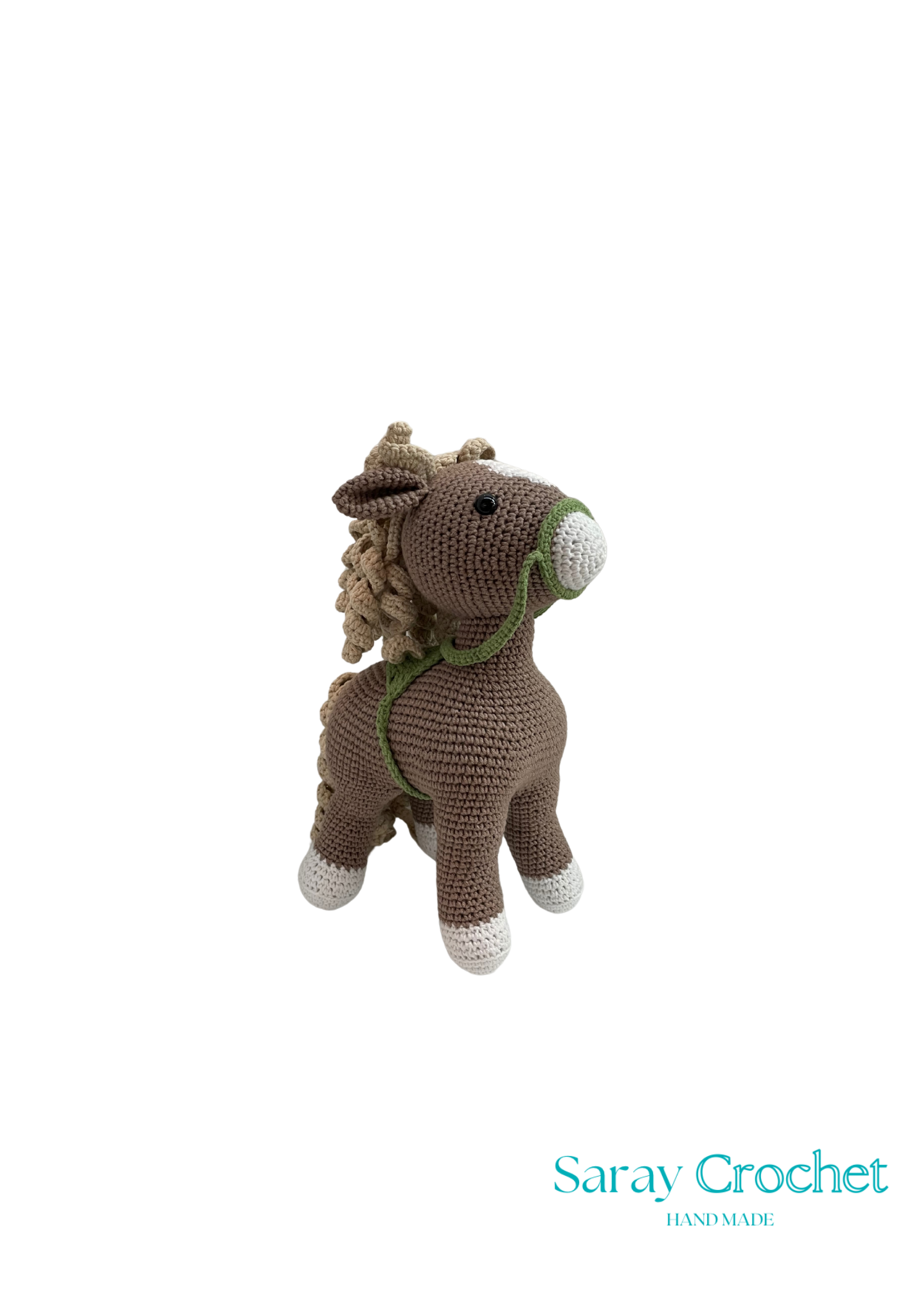 A crochet toy resembling a horse with beige body, green halter, and brown mane and tail.