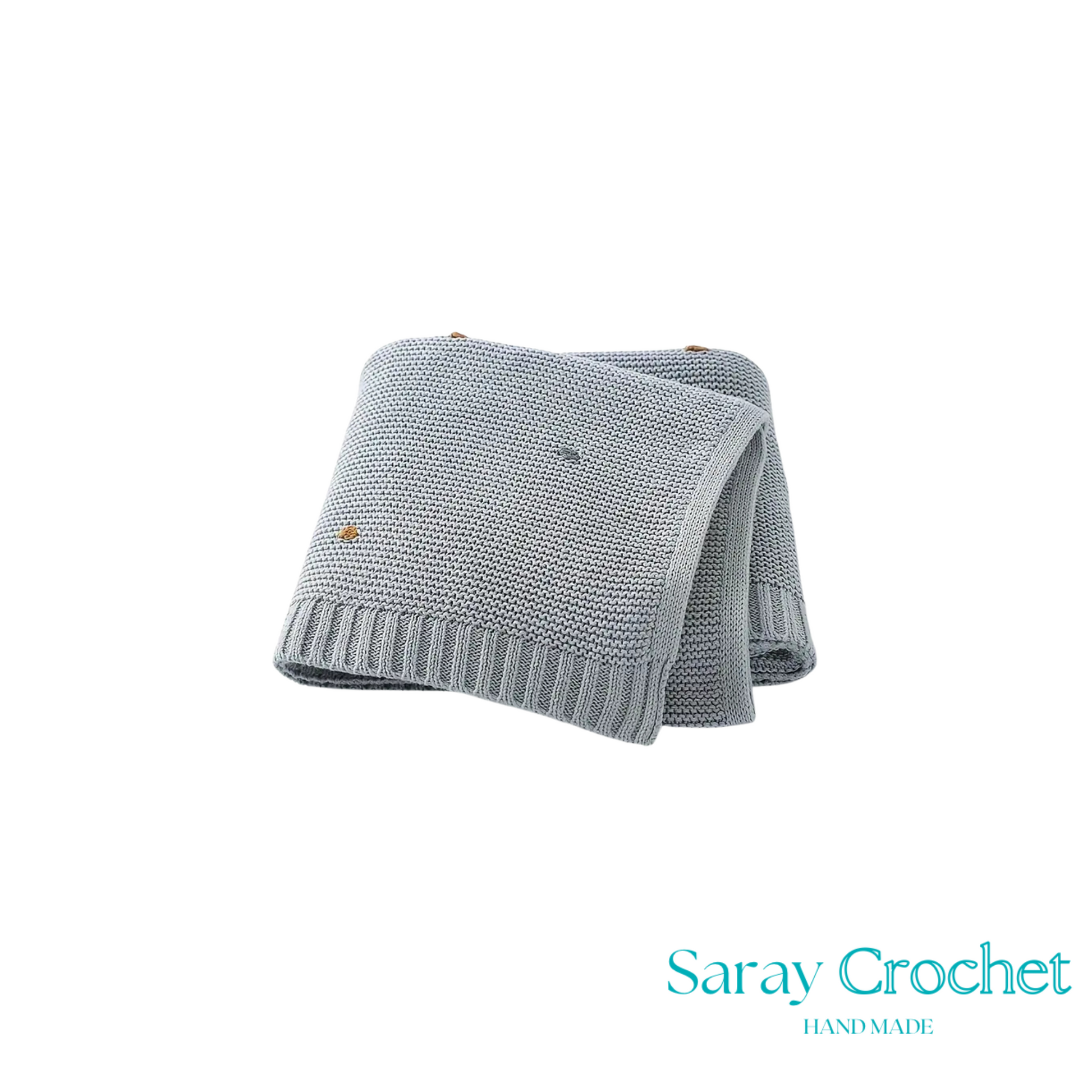 Folded gray knitted blanket with 'Saray Crochet' branding on a white background