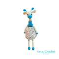 Handmade plush giraffe toy with a floral dress and blue accents, equipped with a pacifier.