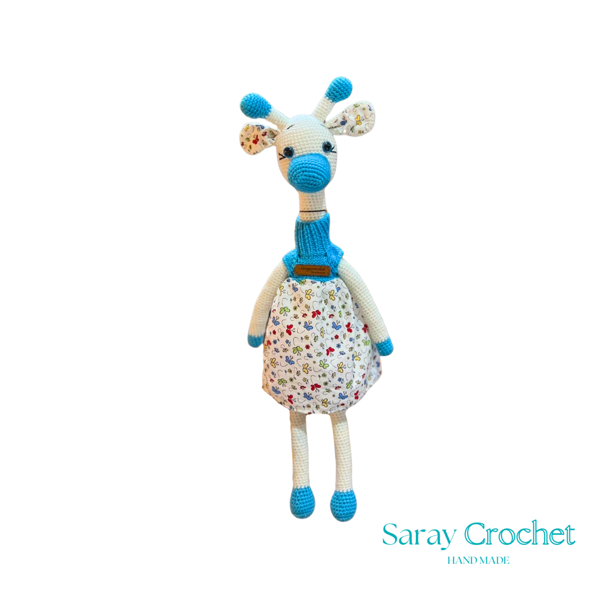Handmade plush giraffe toy with a floral dress and blue accents, equipped with a pacifier.