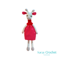 Handmade plush giraffe toy with a red dress and white body, standing upright.