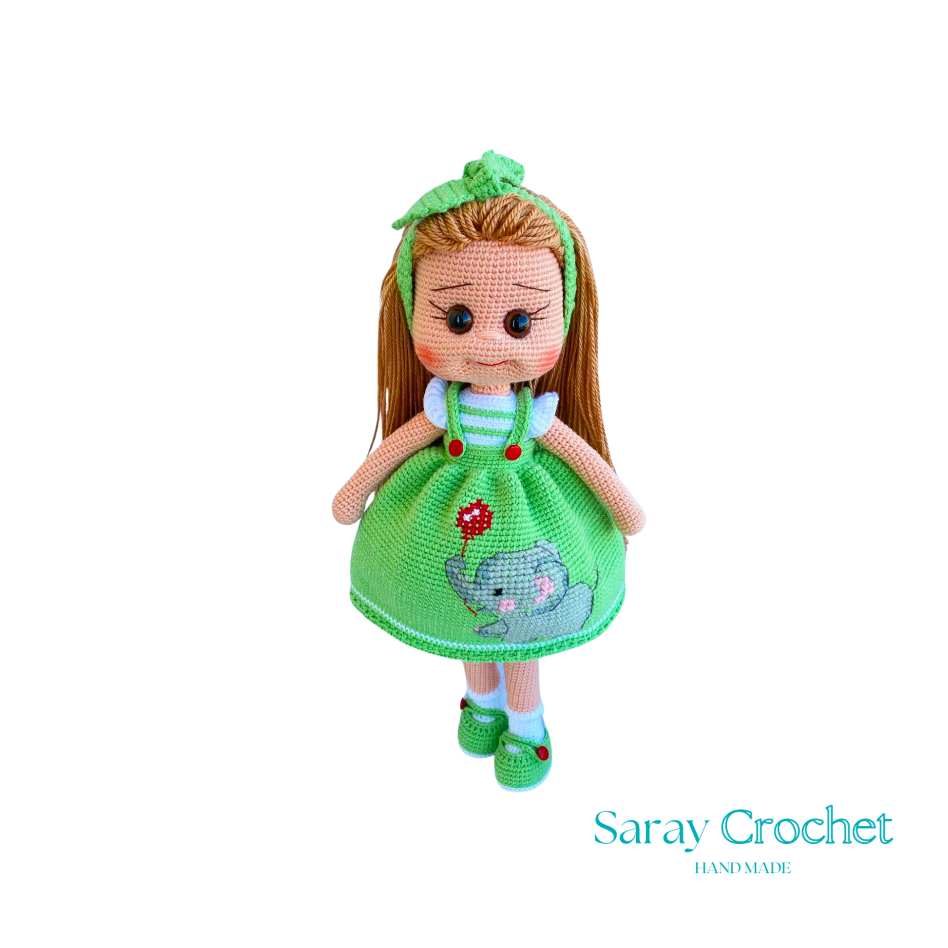 Handmade doll with light green dress, featuring a hand-embroidered snail motif, and a matching green bow in her hair.