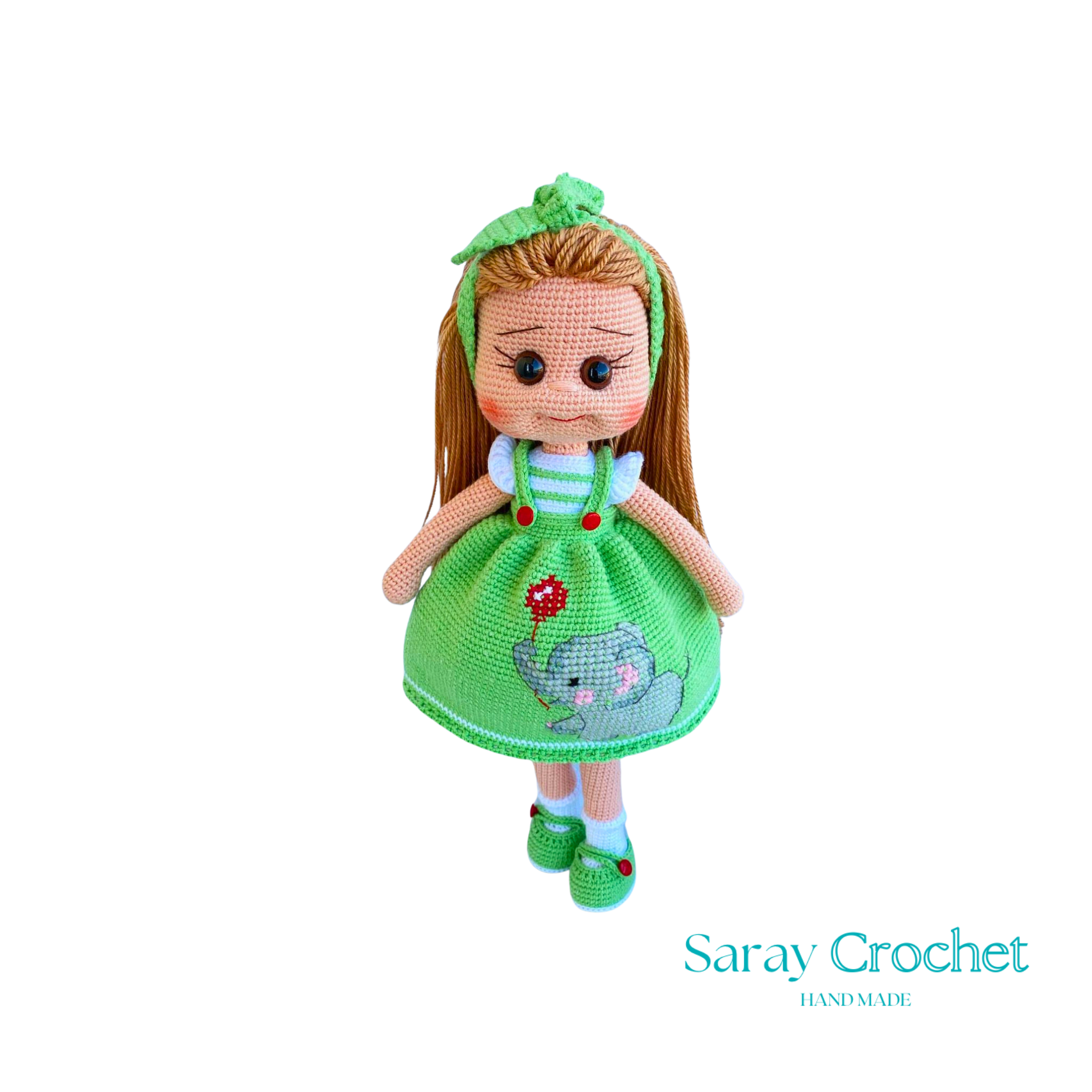 Handmade doll with light green dress, featuring a hand-embroidered snail motif, and a matching green bow in her hair.
