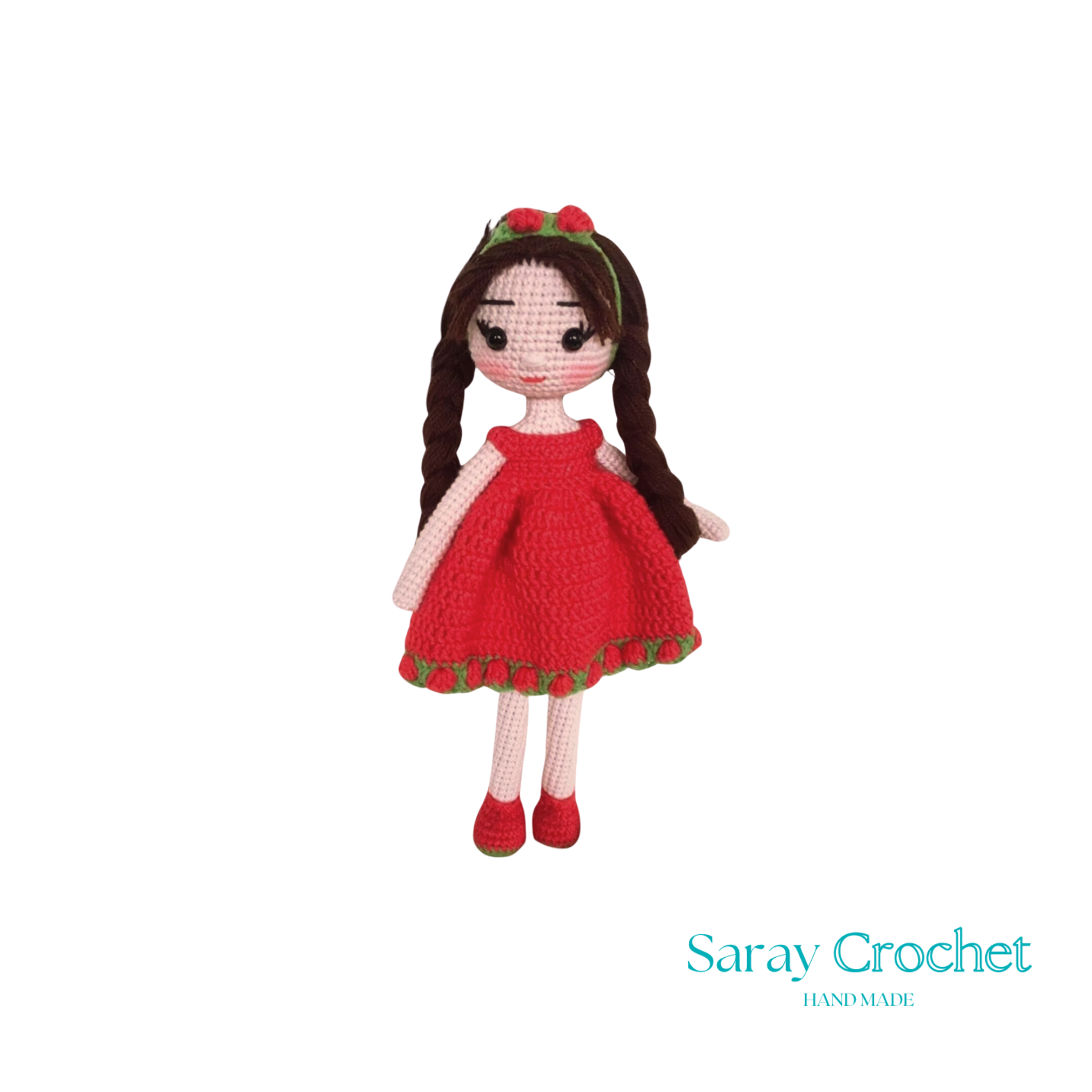 A handcrafted doll with a red dress and matching red shoes, featuring a green hairband with a bow.