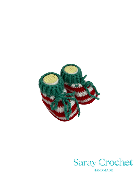 Pair of green and red striped baby booties with 'Saray Crochet' branding on a white background.
