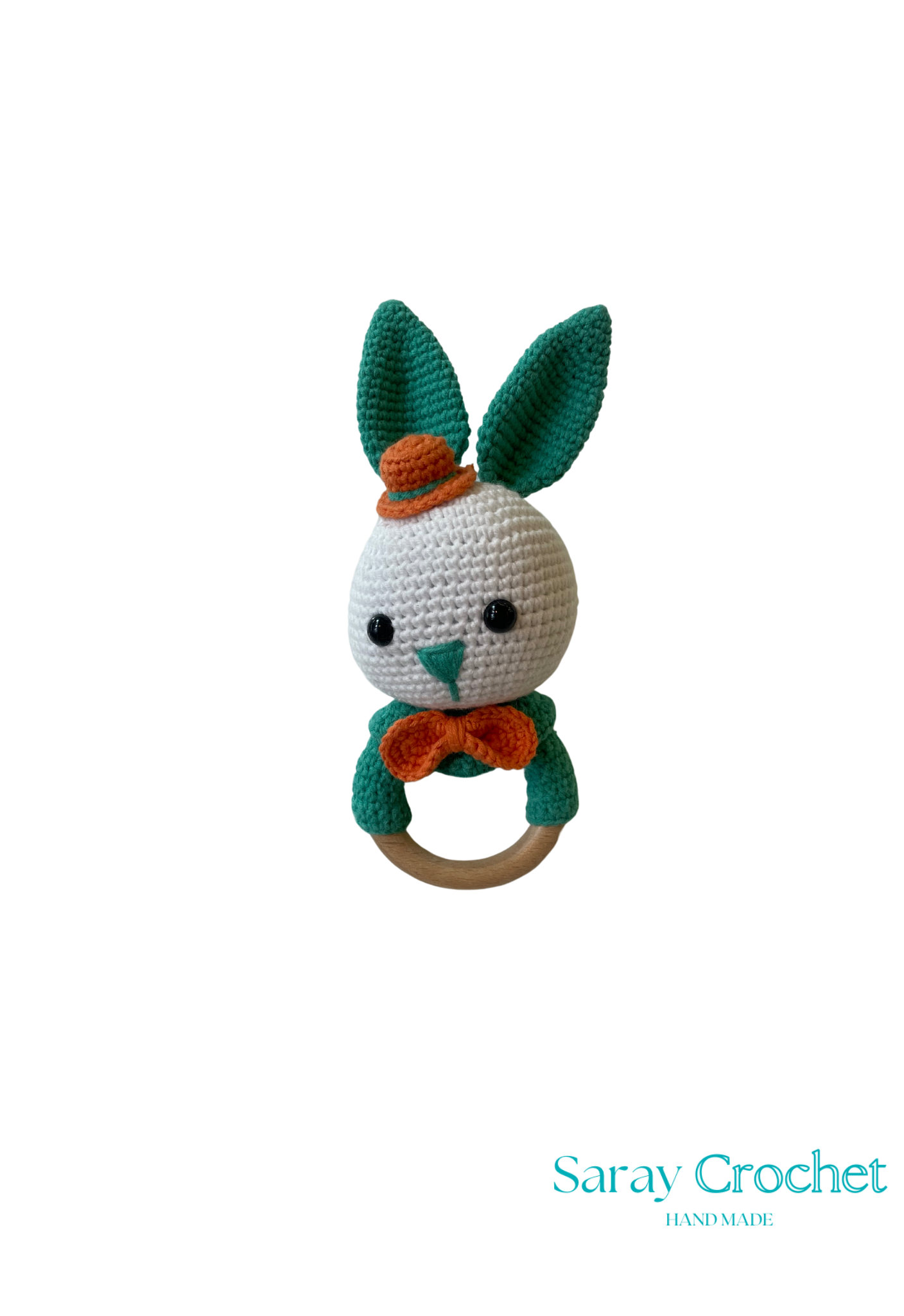A crochet toy resembling a green and white rabbit with an orange collar and a wooden ring attached to its head.