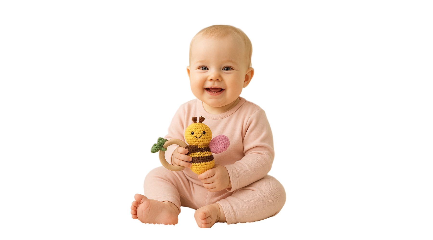 Baby in pink outfit holding a toy with a bee design on a white background